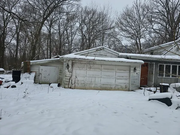 a view of a house with a yard and garage