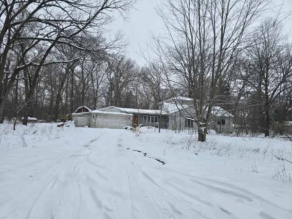 a view of a house with snow on the road