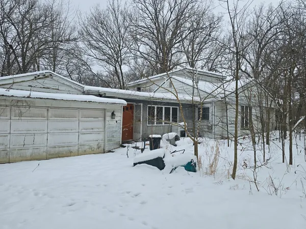 a view of a house with a yard and wooden fence
