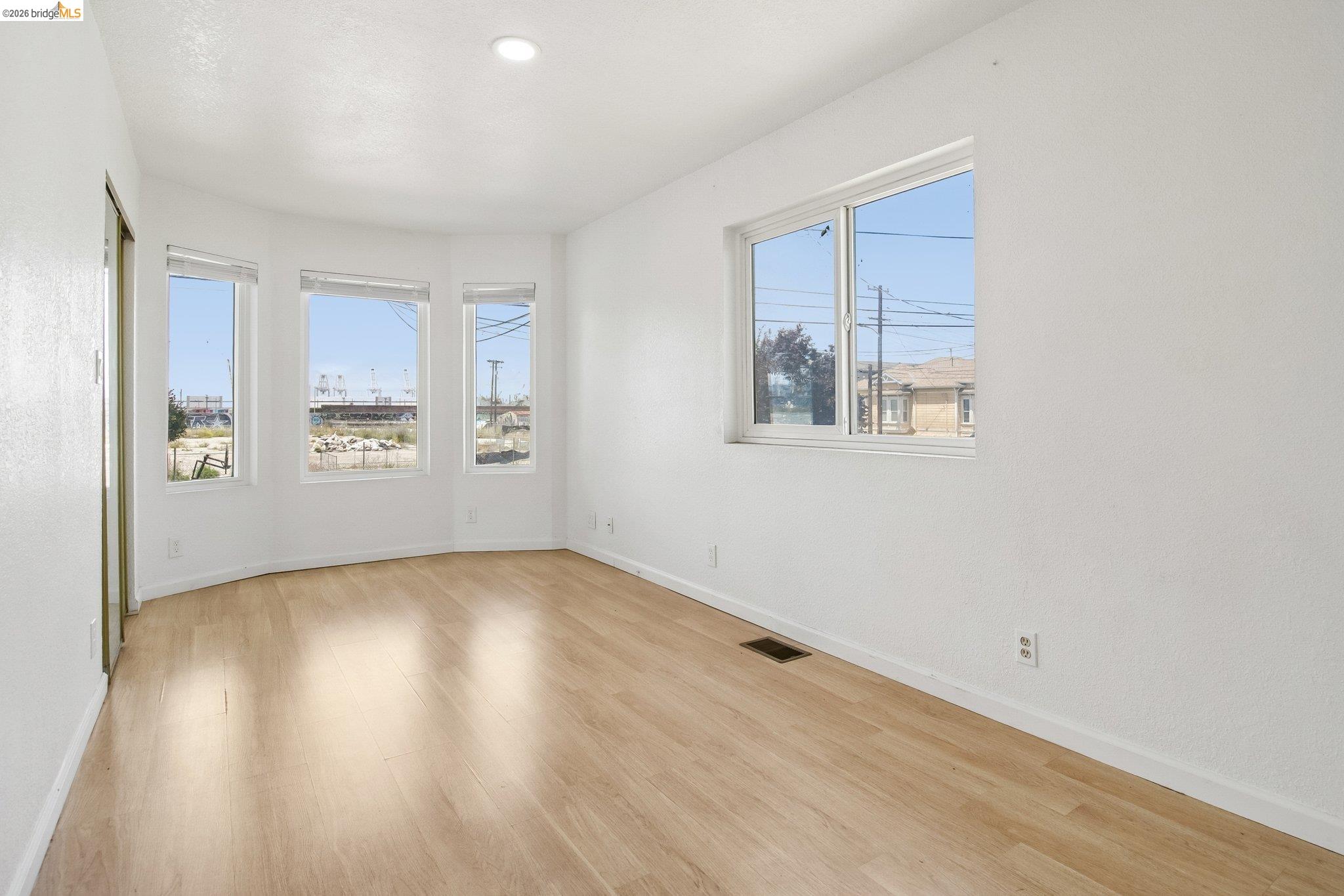 874 Pine Street Oakland, CA 94607 - Photo 14 of 39 Light wood-finish flooring complements the crisp white walls