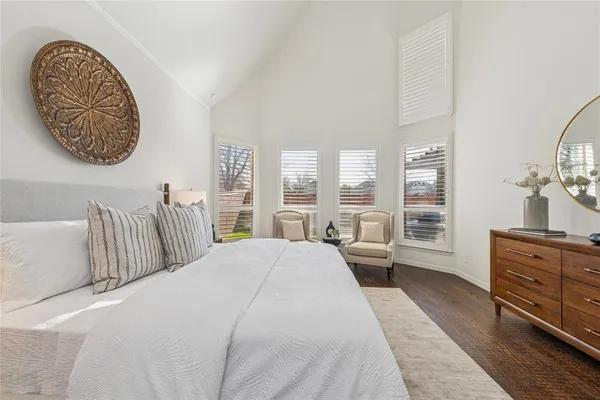 a spacious bedroom with a large bed and a window