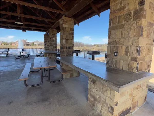 a roof deck with table and chairs