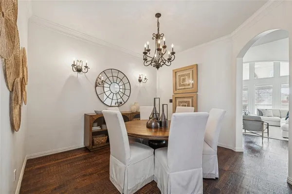 a view of a dining room with furniture wooden floor and a chandelier