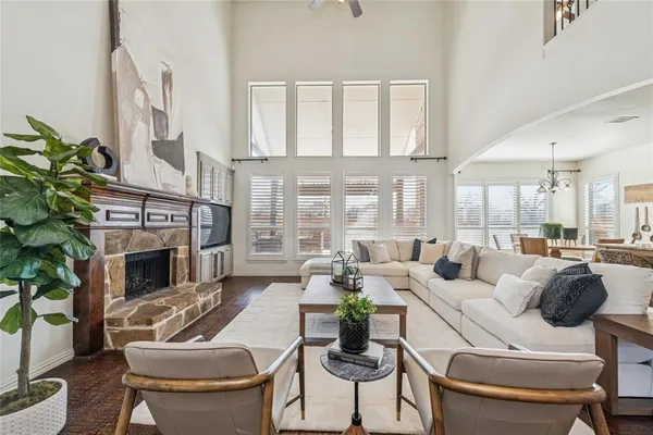 a living room with furniture a fireplace and a potted plant