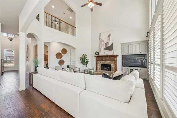 a living room with furniture a fireplace and a large window