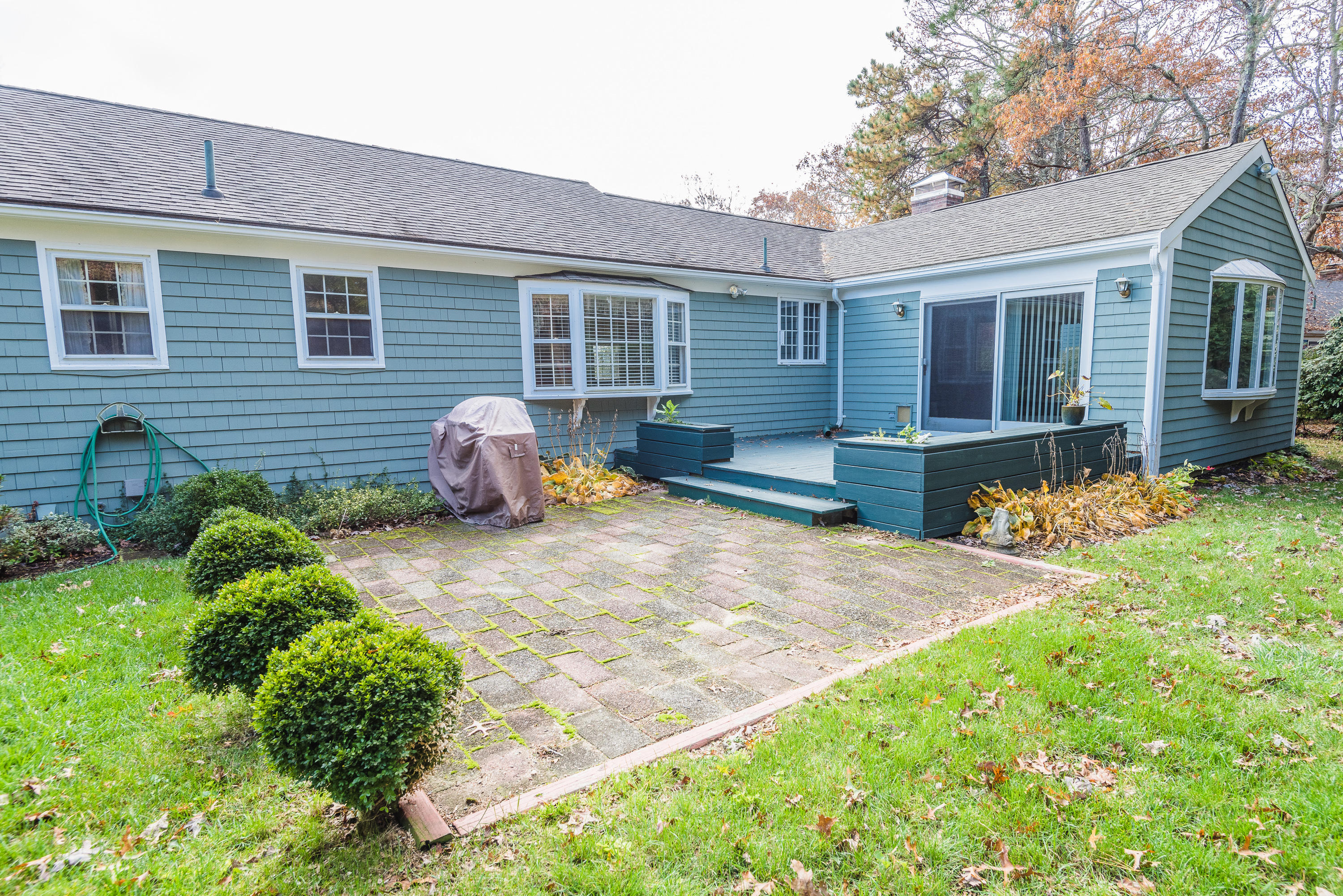 19 Shubael Gorham Road Centerville, MA 02632 - Photo 7 of 9 a front view of a house with a yard and outdoor seating