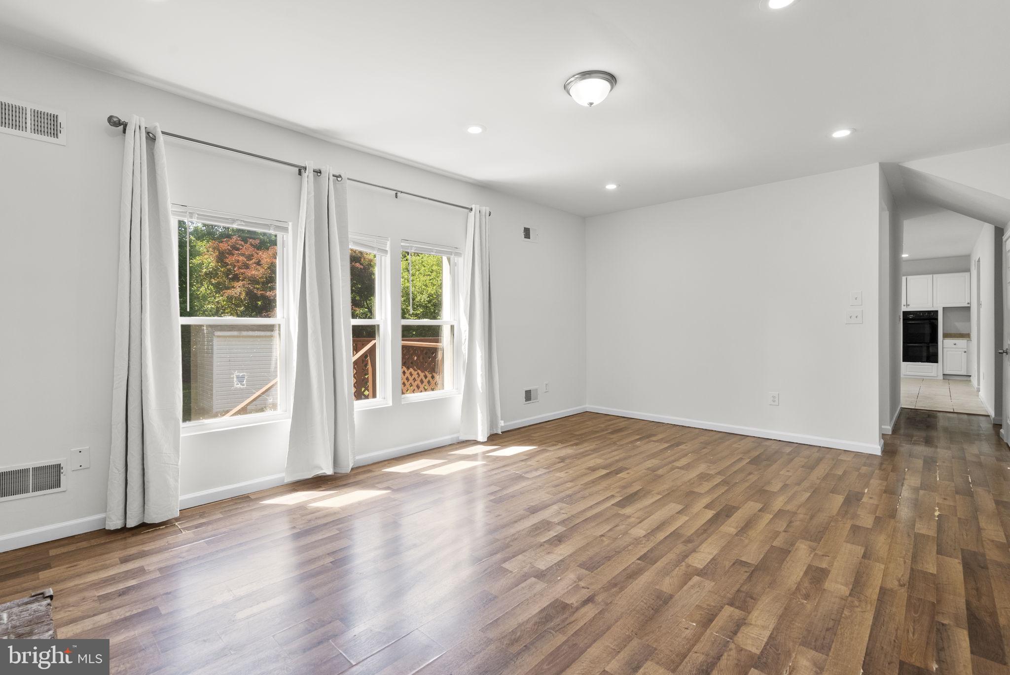 24000 Clarksburg Road Clarksburg, MD 20871 - Photo 18 of 60 a view of an empty room with wooden floor and a window