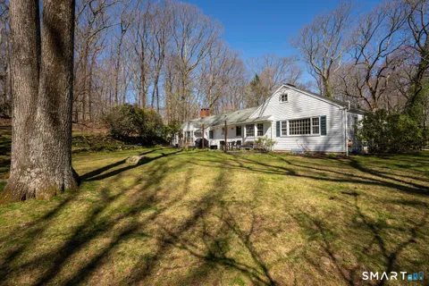 a view of a house with pool and sitting area