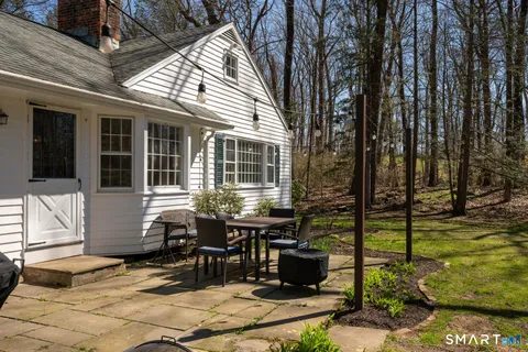 a view of a house with backyard sitting area and garden