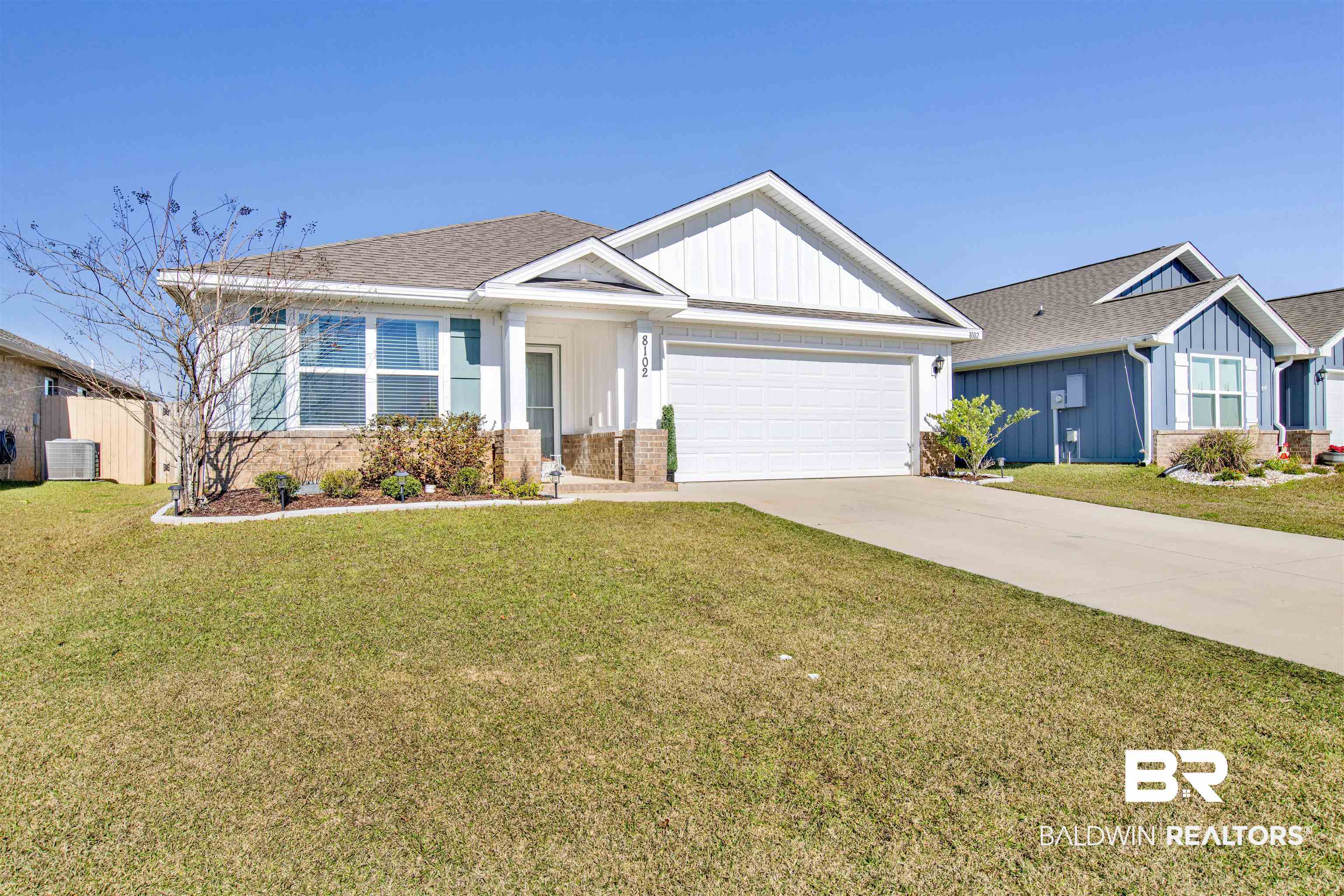 8102 Irwin Loop Daphne, AL 36526 - Photo 2 of 30 View of front of property featuring a front yard, a garage, and cooling unit