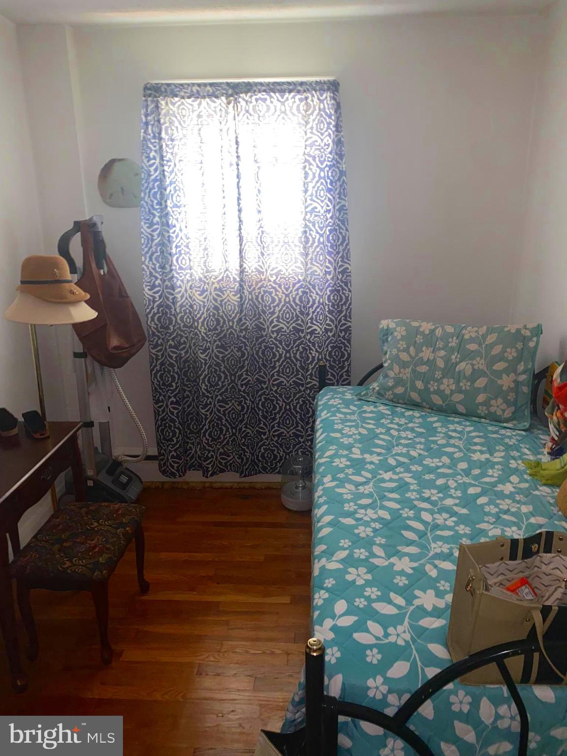 5905 Glenkirk Road Baltimore, MD 21239 - Photo 11 of 15 a bedroom with a bed and a window