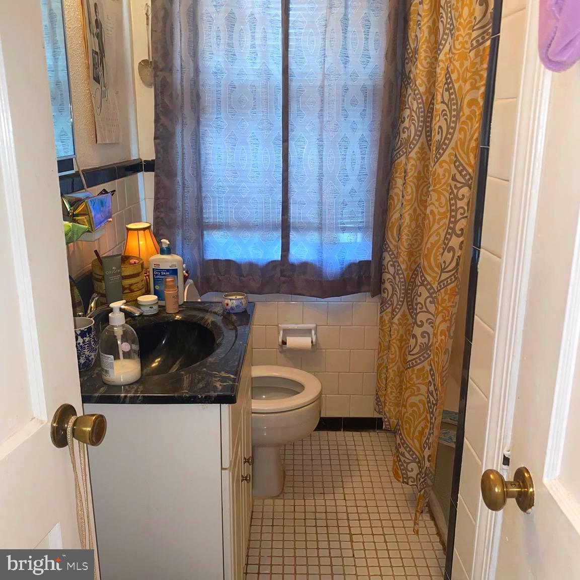 5905 Glenkirk Road Baltimore, MD 21239 - Photo 12 of 15 a bathroom with a sink and toilet