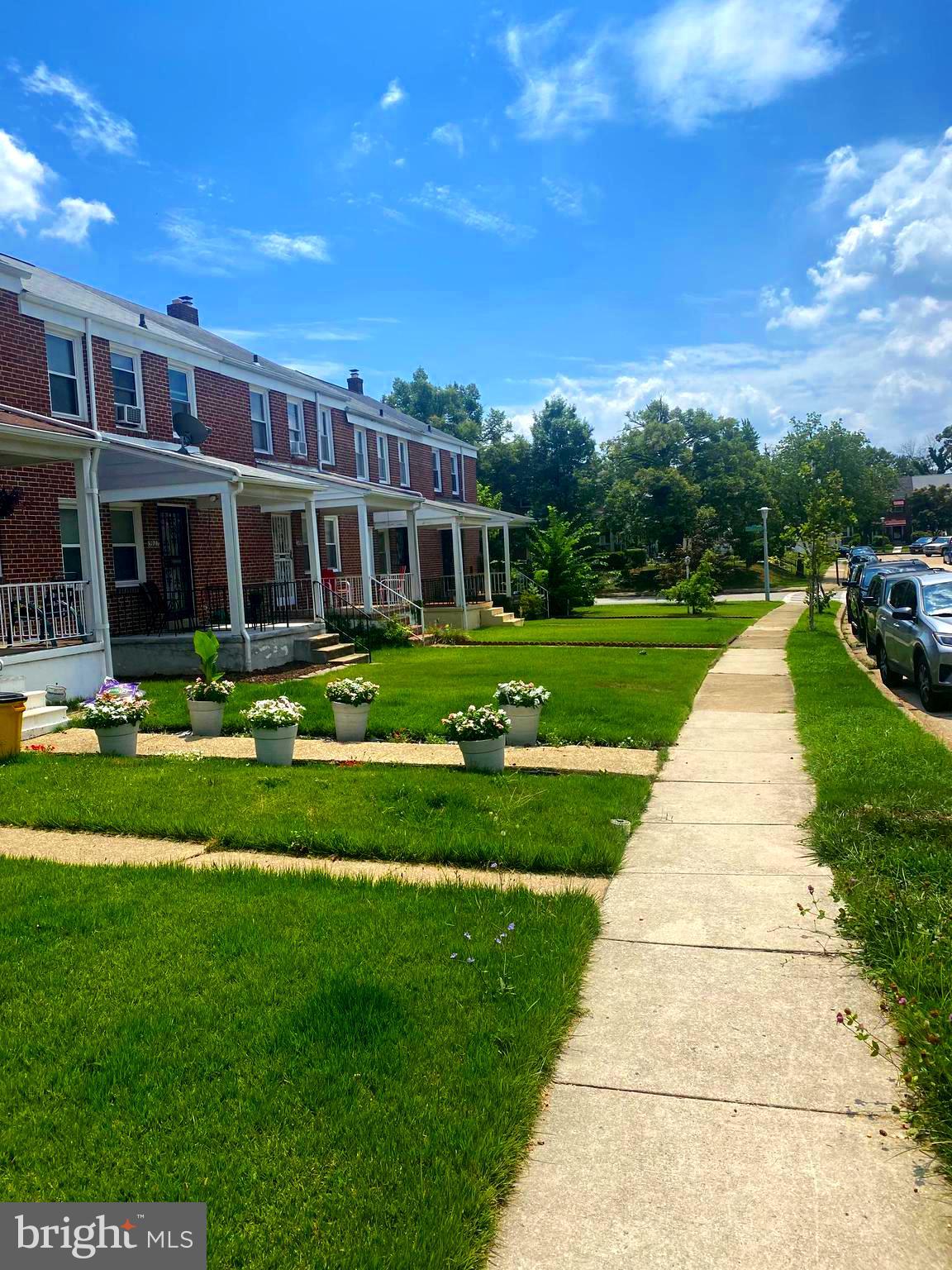 5905 Glenkirk Road Baltimore, MD 21239 - Photo 2 of 15 a front view of a house with a yard table and chairs