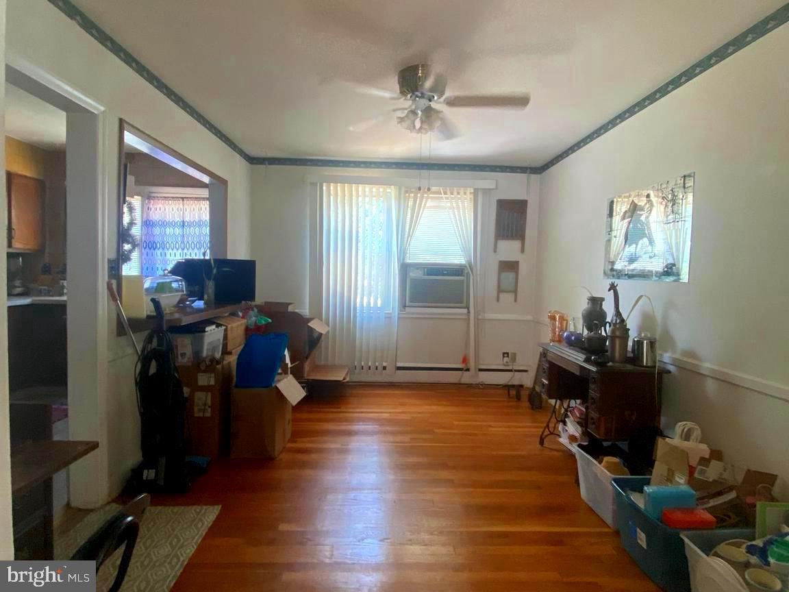 5905 Glenkirk Road Baltimore, MD 21239 - Photo 5 of 15 a living room with furniture and wooden floor