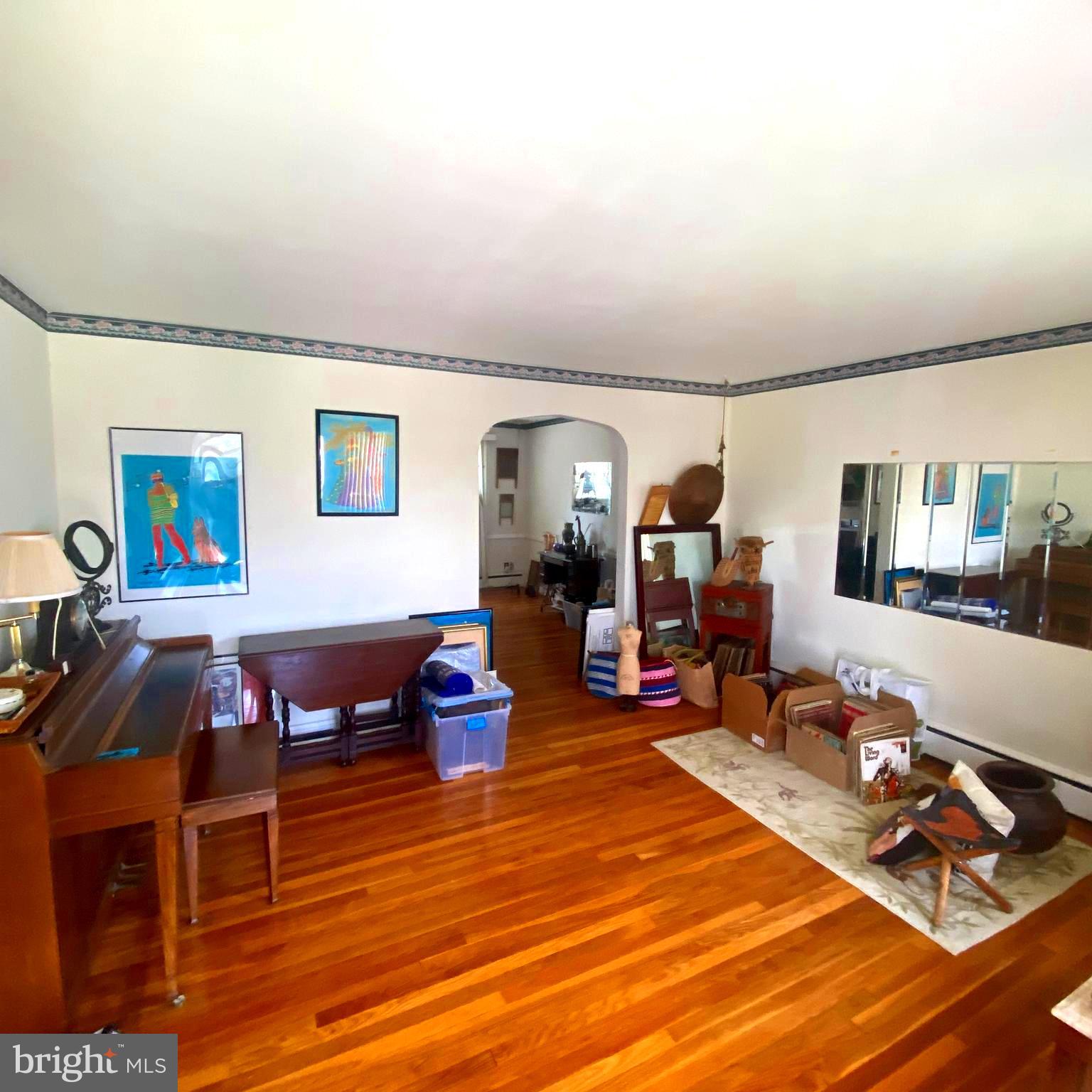 5905 Glenkirk Road Baltimore, MD 21239 - Photo 6 of 15 a living room with furniture a wooden floor and next to a window