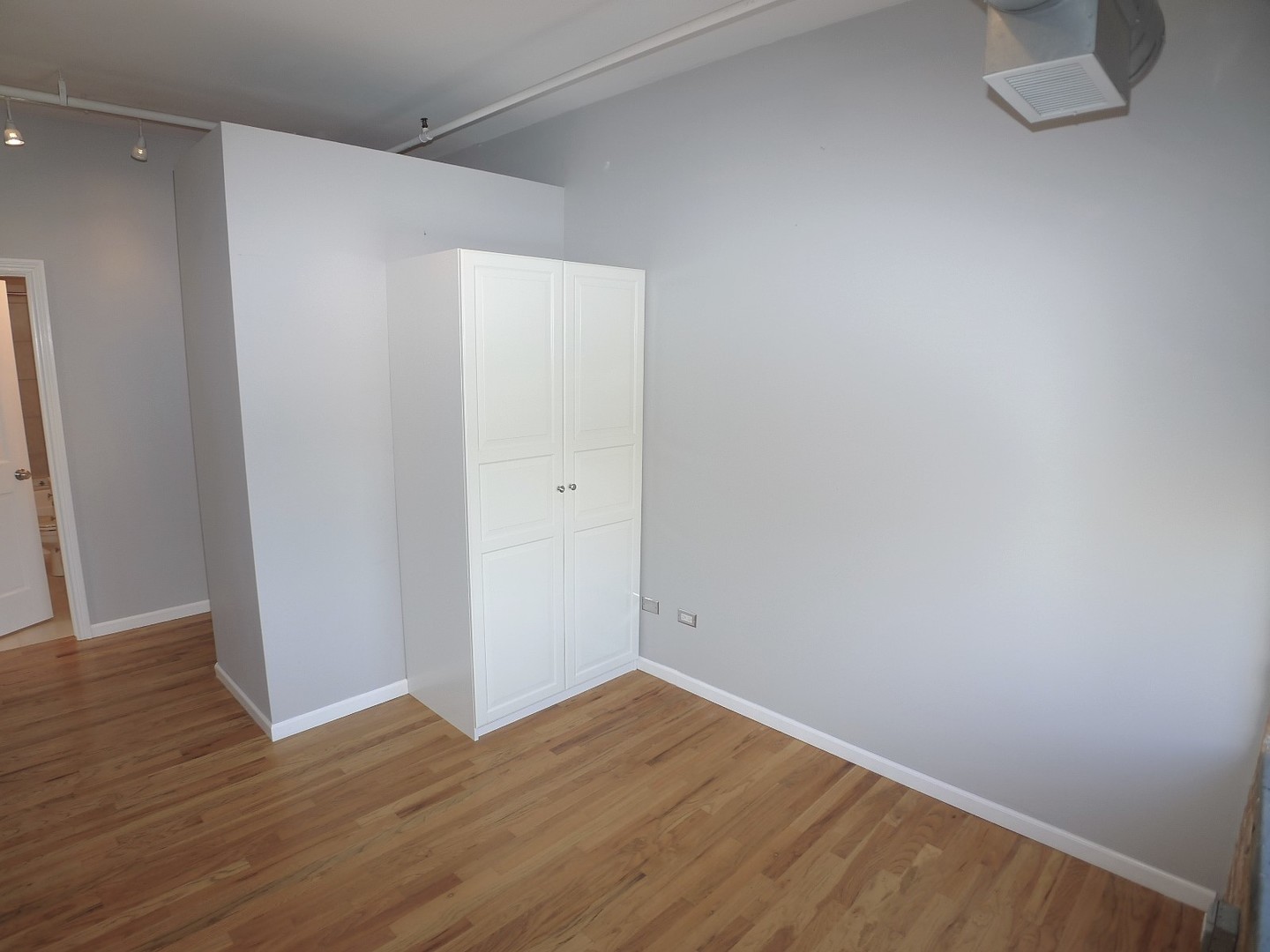 420 South Clinton Street, Unit 401A Chicago, IL 60607 - Photo 12 of 22 a view of an empty room with wooden floor