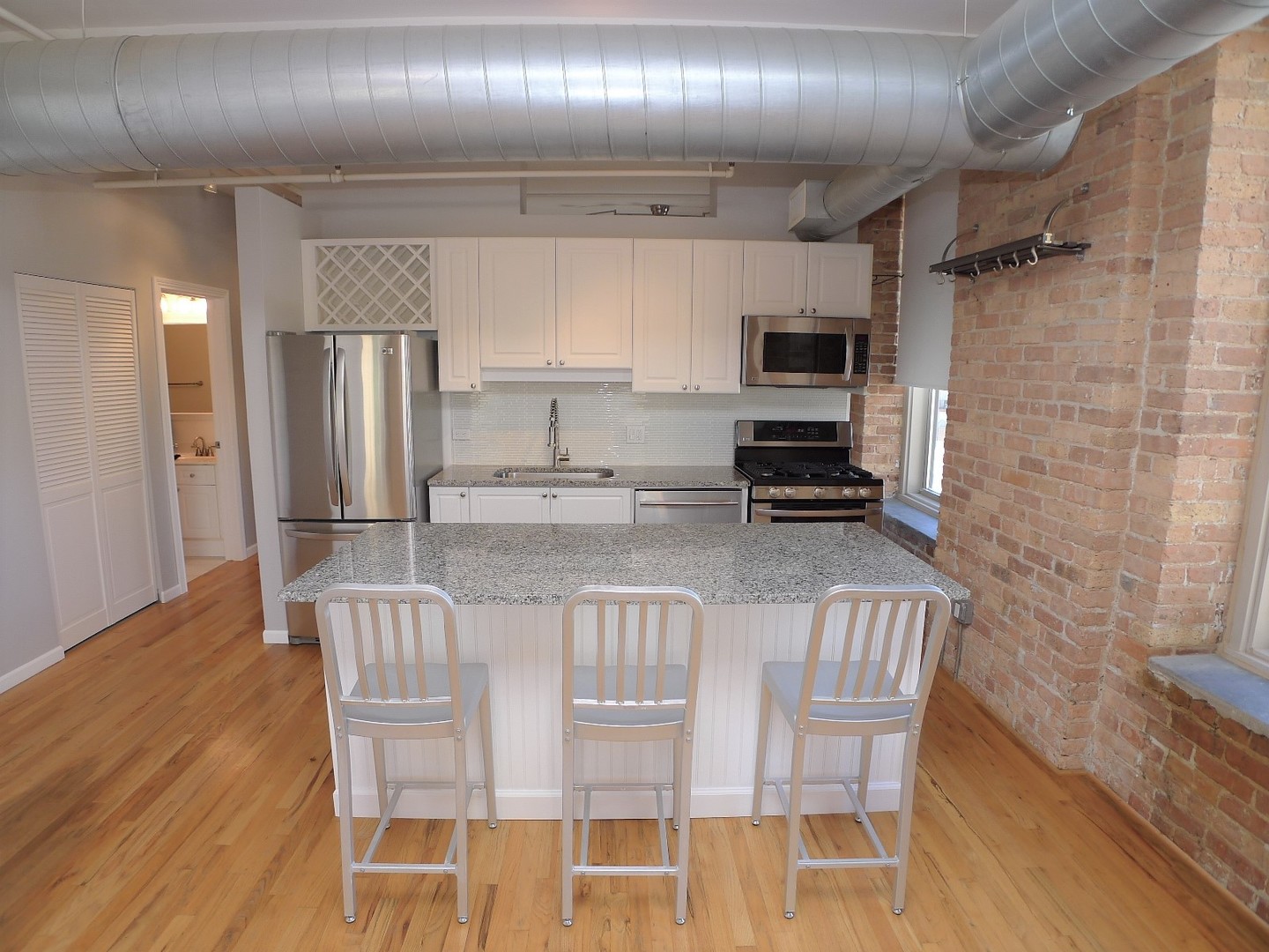 420 South Clinton Street, Unit 401A Chicago, IL 60607 - Photo 2 of 22 a kitchen with stainless steel appliances a refrigerator and microwave