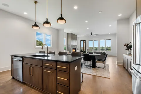 a kitchen with a counter space cabinets and a chandelier