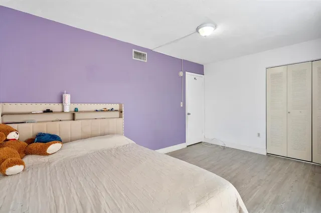 a bedroom with a bed and closet