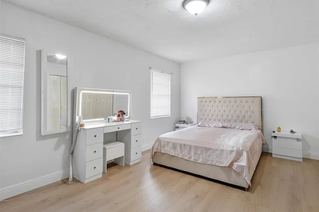 a bedroom with a bed and a night stand