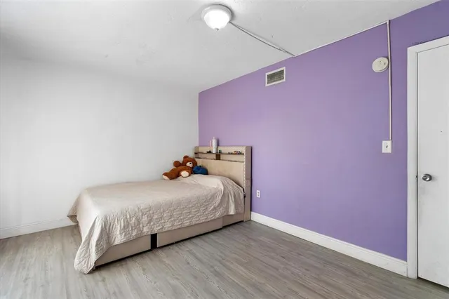 a bedroom with a bed and a dresser