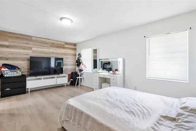 a bedroom with a bed and a flat screen tv