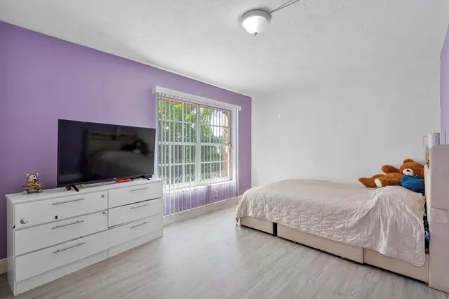a bedroom with a bed and flat screen tv