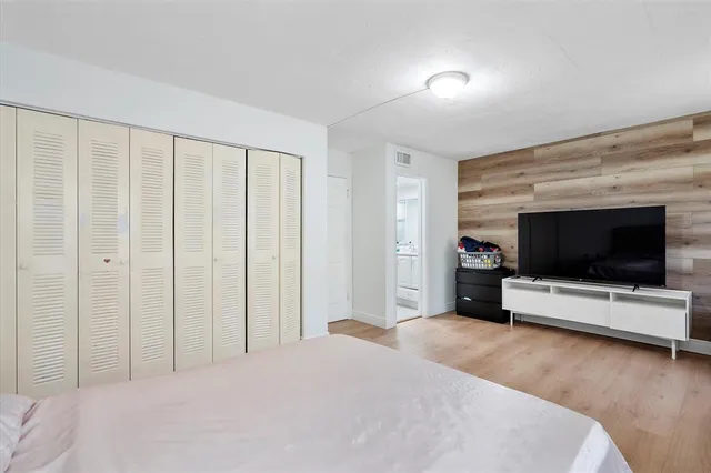 a bedroom with a bed and a flat screen tv