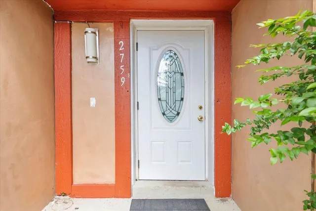 view of door with hallway