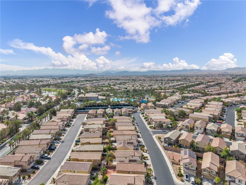 389 Fringe Ruff Drive Las Vegas, NV 89148 - Photo 49 of 53 A sprawling suburban neighborhood unfolds under blue skies with distant mountain views.