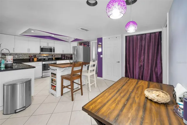 a kitchen that has a table and chairs in it