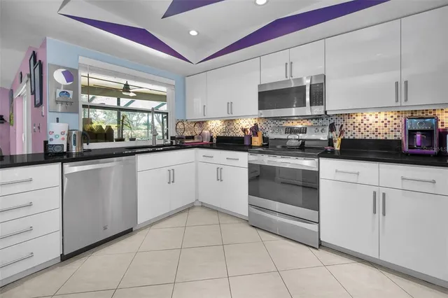 a kitchen with stainless steel appliances granite countertop a sink and cabinets
