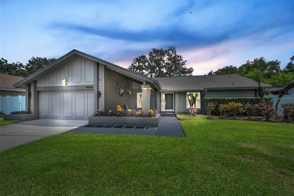 a front view of a house with a yard and garage