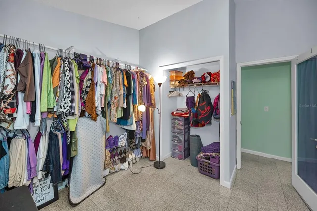a view of walk in closet with clothes