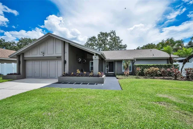 a front view of a house with a yard and porch