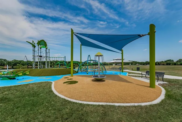 a view of a lake with houses in the back