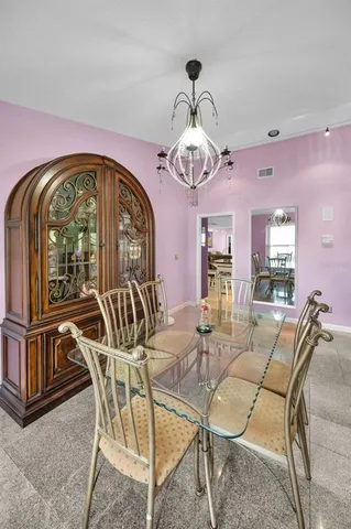 a view of a dining room with furniture wooden floor and chandelier