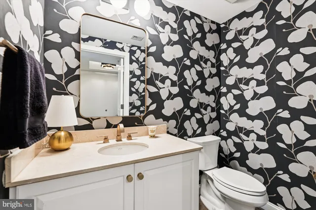 a bathroom with a sink toilet and mirror