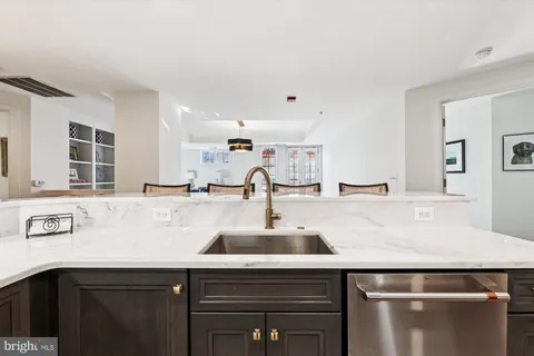 a view with kitchen island a sink a stove and a microwave oven