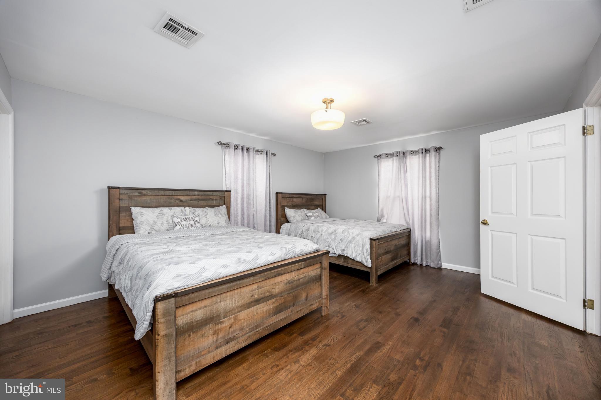 14470 Backbone Road Eden, MD 21822 - Photo 32 of 55 a spacious bedroom with a bed and a night stand