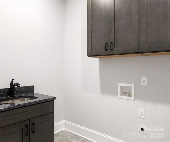 a room with a sink and cabinets
