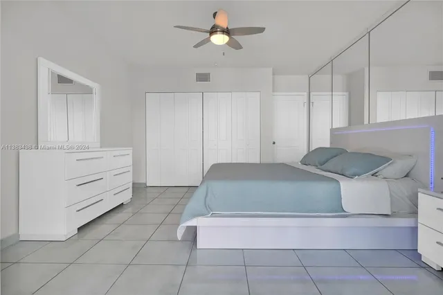 a bedroom with a bed and cabinets