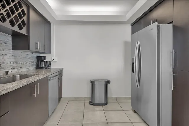 a kitchen with stainless steel appliances a refrigerator and a sink