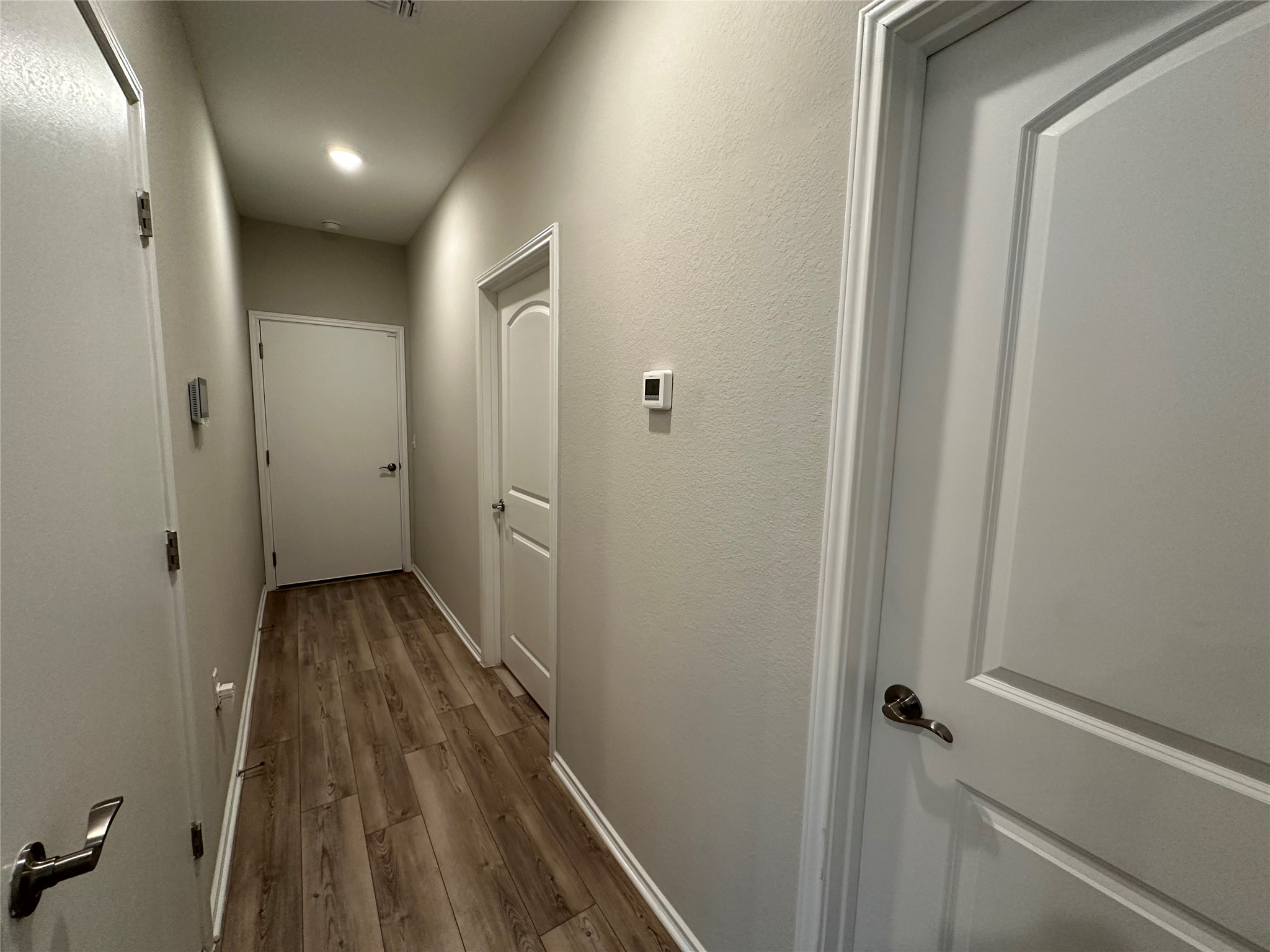 219 Coachsmith Street Georgetown, TX 78633 - Photo 17 of 25 Hall featuring wood finished floors and baseboards