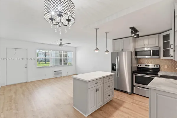 a kitchen with stainless steel appliances a refrigerator sink and cabinets