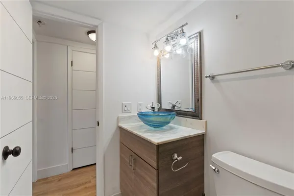 a bathroom with a sink toilet vanity and tub