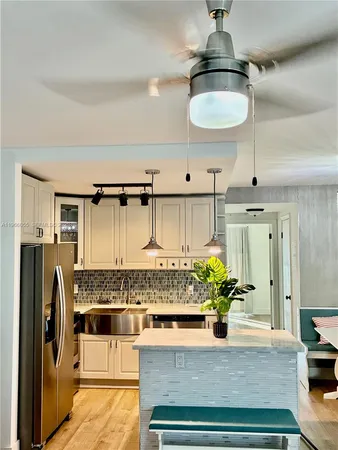 a kitchen with stainless steel appliances granite countertop a stove and cabinets