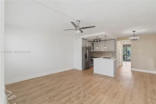 a view of a kitchen with wooden floor