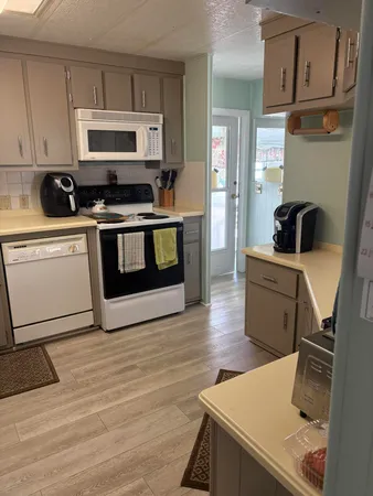 a kitchen with a sink a stove and cabinets