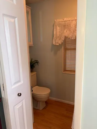 a bathroom with a toilet and a window